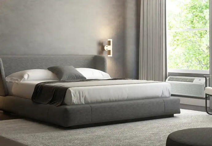 Modern gray upholstered platform bed with white bedding and black accents.