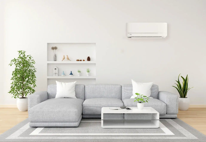 White wall-mounted air conditioner with sleek design and modern aesthetic.