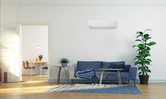White wall-mounted air conditioner with sleek design and modern aesthetic.